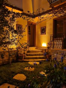 a house with stairs and flowers in the yard at Sezgin Boutique Hotel in Kuşadası