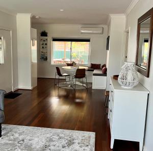 a kitchen and living room with a table and chairs at The Parkview Retreat in Rockingham