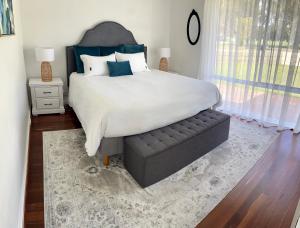 a bedroom with a large bed and a couch at The Parkview Retreat in Rockingham