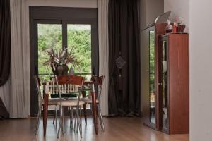 a dining room with a table and chairs and a window at Villa Maltina in Kassandrinón