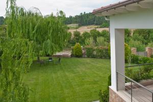 a backyard with a green lawn and a tree at Villa Maltina in Kassandrinón