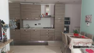 a kitchen with wooden cabinets and a table in it at Appartamento Amy in Perugia