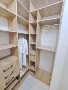 a walk in closet with a white suit in it at Apartment in City Center in Dushanbe