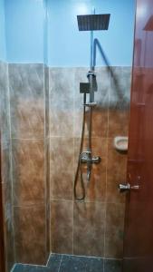 a bathroom with a shower and a toilet at KM Pension 