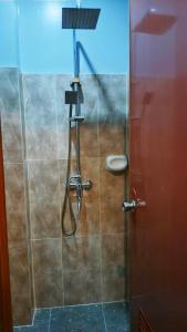 a shower in a bathroom with a glass door at KM Pension 