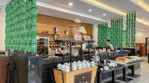a pastry shop with a man standing behind the counter at Premier Village Danang Resort Managed By Accor in Danang