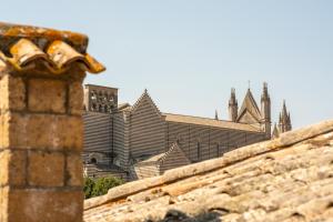 a view of a building behind a stone wall at Hotel Valentino Centro Storico in Orvieto