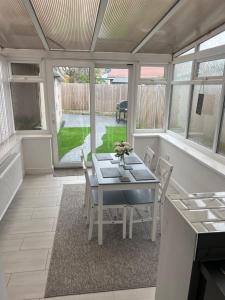 a dining room with a table and chairs at 2 bed semi-detached house in Warrington