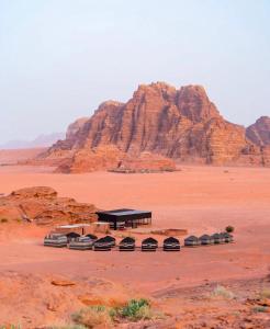 a bus stop in the middle of a desert at Wadi Rum Travel camp in Wadi Rum