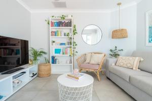 a living room with a couch and a table at Mindarie Retreat in Mindarie