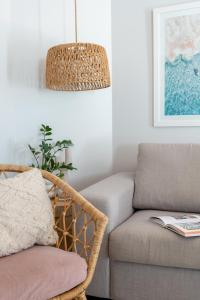 a living room with a chair and a couch at Mindarie Retreat in Mindarie