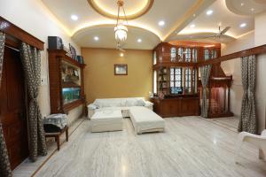 a living room with a couch and a table at Kapoor Sahab Homestay : it's a home away from home. in Varanasi