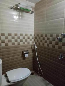 a bathroom with a toilet and a shower at Royal Living Hotel & Suites in Chittagong
