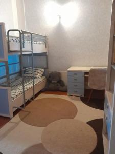 a bedroom with a bunk bed and a desk at 2-storey apartment in Mardakan