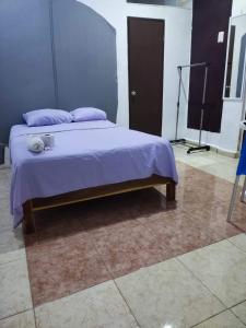 a bedroom with a bed with a purple blanket at Ángel in Campeche