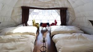a room with three beds in a tent at Oak Village in Hakuba