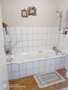 a white bathroom with a tub and a sink at Leopards and Louries Bush Lodge in Camperdown