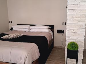 a bedroom with a large bed with white pillows at Tenuta Nonno Peppe in Fermo