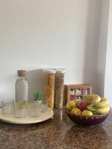 a counter top with a bowl of fruit and other ingredients at Lovely 2 bedrooms appartment with rooftop in Temara