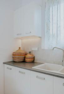 two baskets sitting on a counter in a kitchen at Kaliva Residence in Kalamaki