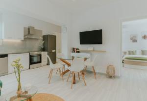 a kitchen with a table and chairs in a room at Kaliva Residence in Kalamaki +21 photos