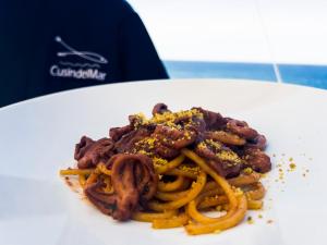 a white plate of food with spaghetti and meat at Hotel Rex in Livorno