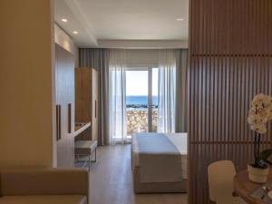 a living room with a bedroom with a view of the ocean at Hotel Rex in Livorno