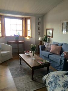 a living room with a blue couch and a coffee table at Lovely home in Inkoo by the sea in Inkoo