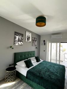 a bedroom with a bed with a green headboard at LuxVilla AURORA in Vodice +43 photos
