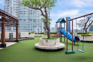 a playground with a slide and a tree at Sattva by Kozystay - Next to Mall in Jakarta