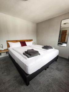 um quarto com uma grande cama branca com toalhas em Kontraste em Neumünster