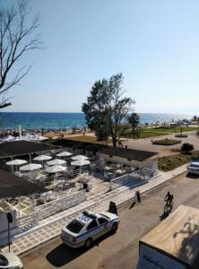 a car parked in a parking lot next to a beach at Angel Room 1 in Nea Plagia