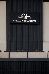 a sign on the side of a building with plants at Ah Villaglori Boutique Apartments in Brescia