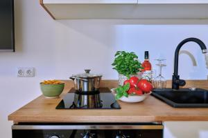a kitchen counter with a coffee pot and vegetables on it at Ferienwohnung Zimmer Tittmoning Stadtplatz 27 in Tittmoning