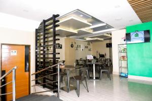 a dining room with tables and chairs in a store at Vivien's Hotel in Mactan
