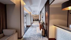 a hallway with a lobby with a long corridor at DIFFERENT HOTEL in Tabuk