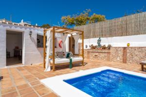 een patio met een zwembad en een huis bij Casa Herrero in Nerja