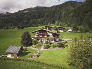 an aerial view of a house in a green field at Sonnenhang Montafon in Sankt Gallenkirch