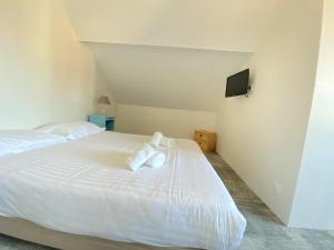 a bedroom with a white bed with towels on it at Hôtel Restaurant Le Sainte Marguerite in Pornichet +24 photos