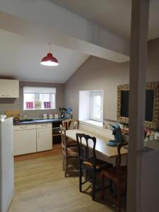 a kitchen and dining room with a table and chairs at Mer&Campagne Wimille in Wimille