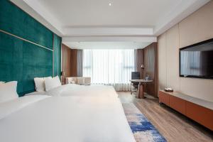 Postel nebo postele na pokoji v ubytování Gao Shi Di Hot Spring Hotel Yangzhou
