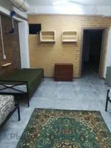 a room with a bed and a rug in a room at Фэмили хостел in Almaty