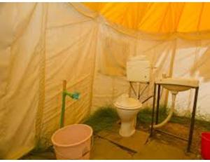 a bathroom with a toilet in a tent at Dorje Camps Sarchu, Manali in Manāli