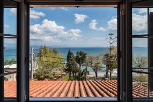 a view of the ocean from a window at The Seaview Corner Apartments by Konnect, Ipsos Corfu in Ýpsos
