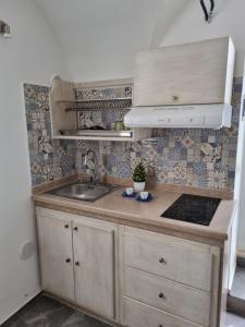 a kitchen with a sink and a counter top at SUITE AGATA in Gallipoli