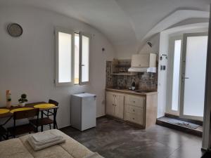 a kitchen with a table and a refrigerator in it at SUITE AGATA in Gallipoli
