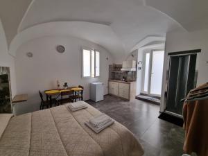 a bedroom with a large bed and a table at SUITE AGATA in Gallipoli +17 photos
