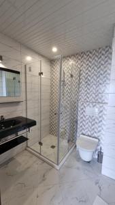 a bathroom with a shower and a toilet and a sink at Hotel Diamanti in Sozopol +45 photos