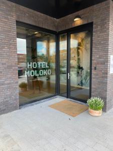 a store with large glass doors in a brick building at hotel Moloko -just a room- sleep&shower-digital key by email-SMS in Enschede