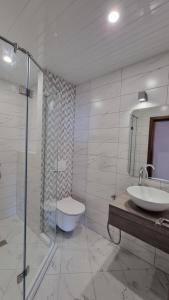 a bathroom with a sink and a toilet and a shower at hotel DIAMANTI in Sozopol
